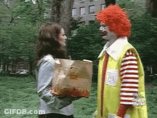 McDonald's Clown Giving Woman Bag Of French Fries GIF