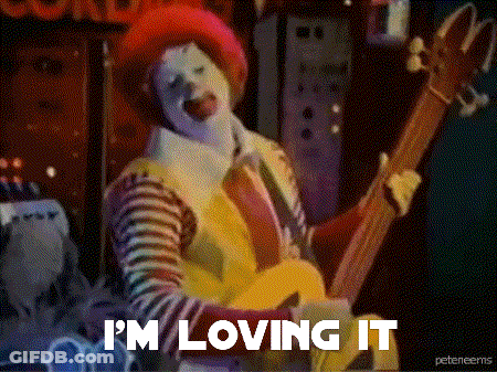 Mcdonald 'S Clown Playing A Guitar With The Words I 'M Loving It Below Him GIF