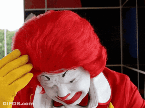 McDonald's Clown Scratching Head With Red Hair And Yellow Gloves GIF