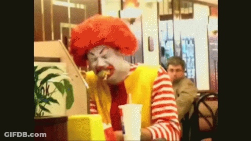 McDonald's Clown Sitting At Table With Drink GIF
