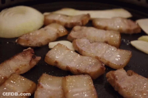 Meat Cooking In Pan With Onions And Garlic GIF