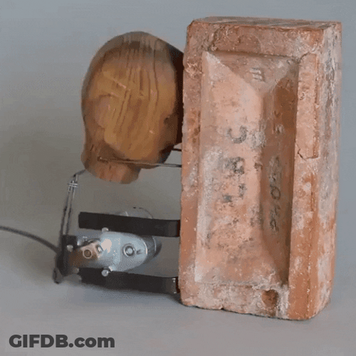 Mechanical Wooden Structure Banging Head Against Wall GIF
