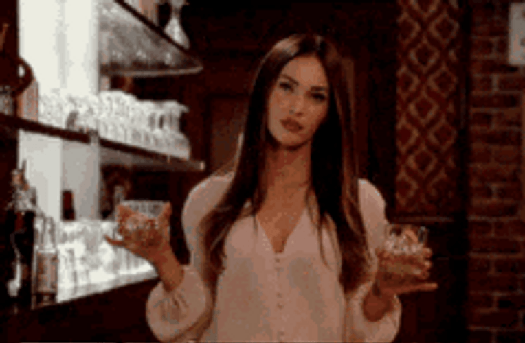 Megan Fox Holding Drinks And Smiling GIF