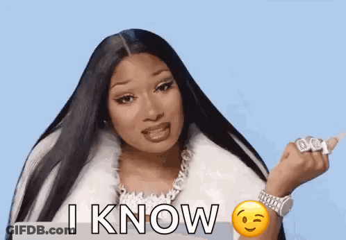 Megan Thee Stallion In White Fur Coat With Smiley Face Wrist GIF