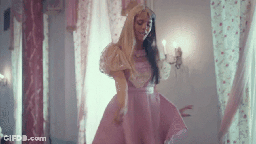 Melanie Martinez Wiping Table With Feet GIF