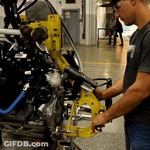 Men Assembling A Snowmobile GIF