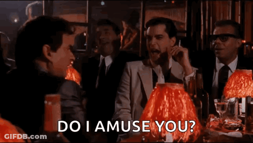 Men At Table With Red Lamps Asking Do I Amuse You GIF