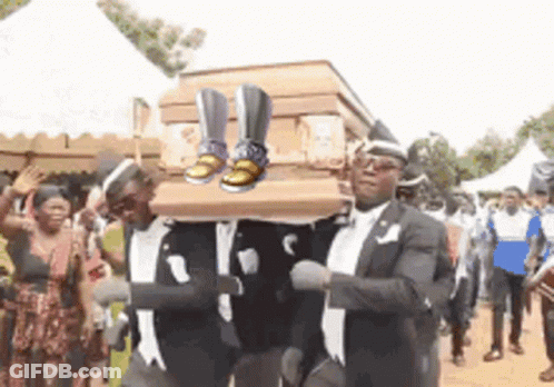 Men Carrying Coffin With Shoes GIF