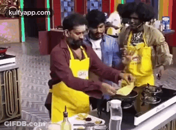 Men Cooking Around Kitchen Table GIF