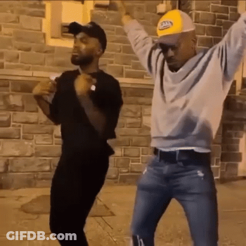 Men Dancing In Front Of Brick Wall GIF