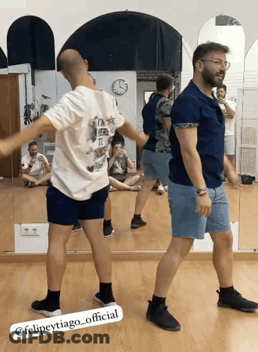Men Dancing In Front Of Mirror In Dance Studio GIF