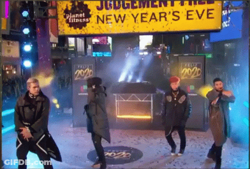 Men Dancing In Front Of New Year's Eve Sign GIF