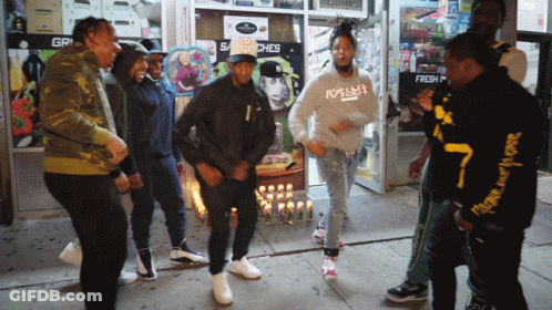 Men Dancing In Front Of Store Saying Gr GIF