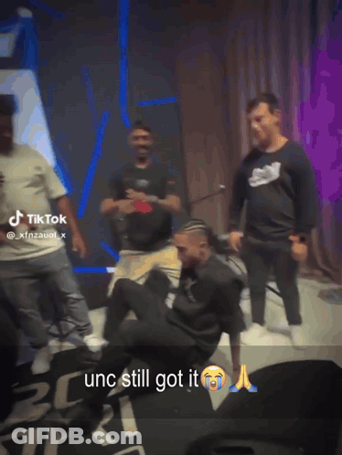 Men Dancing In Front Of TikTok Sign GIF