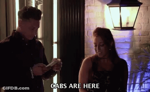 Men Dancing In Living Room While Woman Sits On Couch GIF