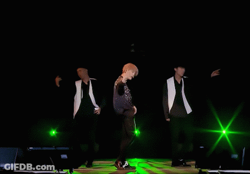 Men Dancing On Stage With Green Lights GIF