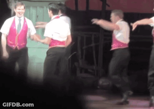 Men Dancing On Stage With Pink Vest GIF