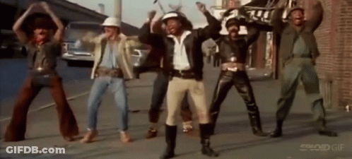 Men Dancing On Street In Front Of Building GIF