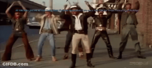 Men Dancing On Street With Brick Wall GIF