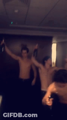 Men Dancing Shirtless In Dark Room GIF