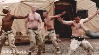 Men Dancing Shirtless In Front Of Tent GIF