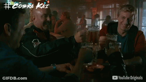 Men Drinking Beer At Table With YouTube Originals Ad GIF