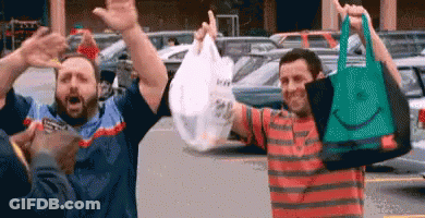 Men Holding Shopping Bags And Celebrating GIF