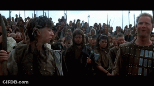 Men Holding Spears In Front Of Crowd GIF