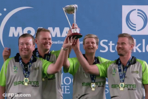 Men Holding Trophy In Front Of Sports Logo GIF