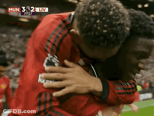 Men Hugging On Soccer Field GIF