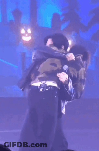 Men Hugging On Stage GIF