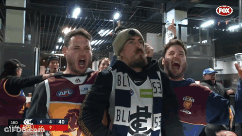 Men In AFL Jerseys Standing In Front Of Scoreboard GIF