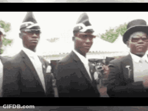 Men In Black Suits And Hats Standing Together GIF