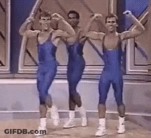Men In Blue Leotards Flexing And Dancing GIF