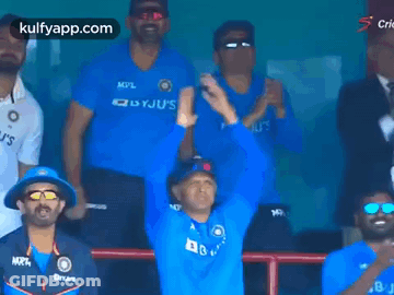 Men In Blue Shirts Applauding In Stadium GIF