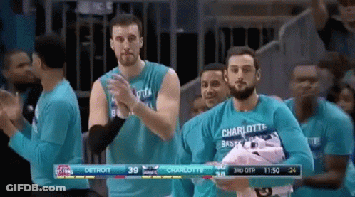 Men In Blue Shirts Applauding In Stadium GIF