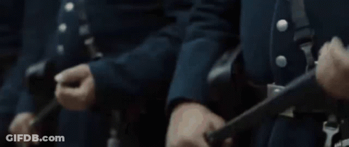 Men In Blue Uniforms Standing In Line GIF