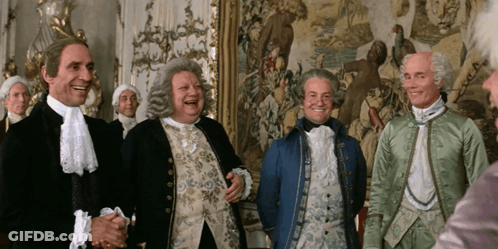 Men In Costume Laughing In Front Of Tapestry GIF