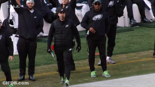 Men In Eagles Sweatshirts Walking On Football Field GIF