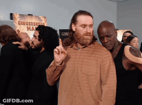 Men In Front Of Gingerbread Man Sign GIF