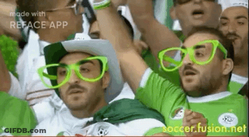 Men In Green Glasses And Hats Watching Soccer GIF
