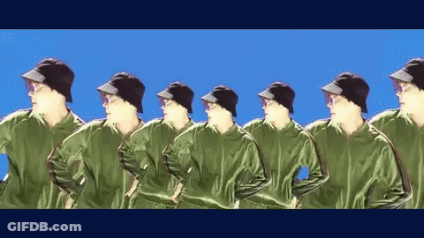 Men In Green Jackets And Black Hats In Row GIF