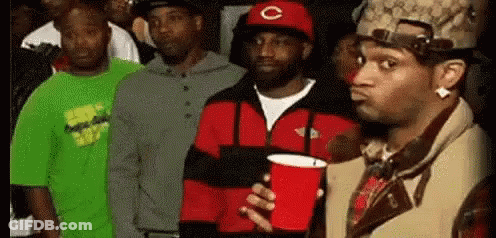 Men In Line One Holding Red Cup GIF