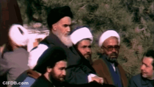 Men In Line, One With Beard And Hat GIF