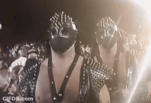 Men In Masks And Studded Outfits GIF
