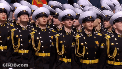 Men In Military Uniforms Lined Up GIF