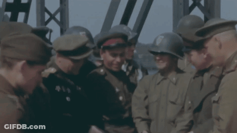 Men In Military Uniforms Standing In Circle GIF