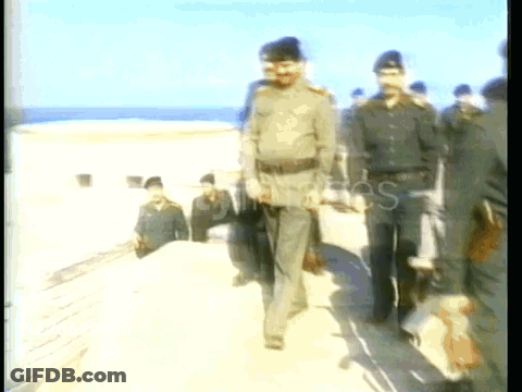 Men In Military Uniforms Walking On Beach GIF