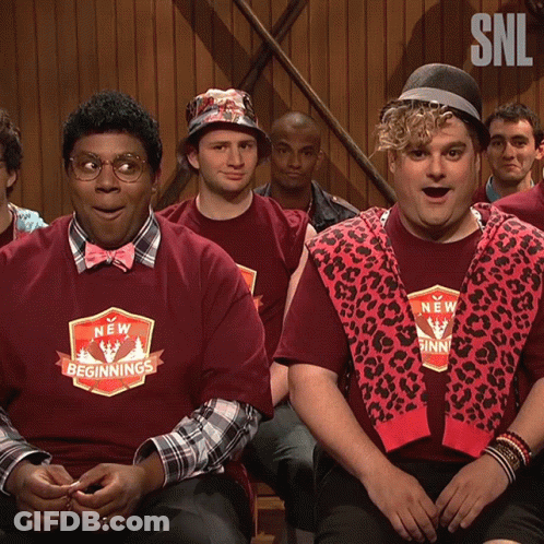 Men In New Beginnings Shirts Sitting In Room GIF