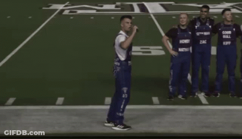 Men In Overalls Saying Good Bull On Football Field GIF